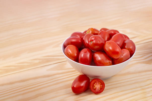 istock Cherry tomatoes wet.Cherry tomatoes in ceramic bowl on wooden background 1070608792
