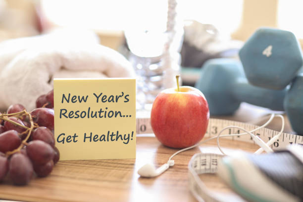 New Year's Resolution to Get Healthy! New year's resolution to get healthy in the coming year! Group of objects includes: note pad, fruit, tape measure,ear buds, athletic shoes, dumbbells, water bottle and towel. Concept of an individual preparing items for an exercise. 2019 new year resolution stock pictures, royalty-free photos & images