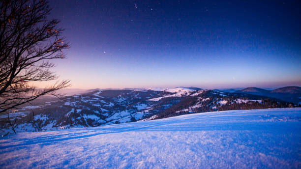 istock Fog moving over the mountain in winter with a star-shaped sky 1070619796