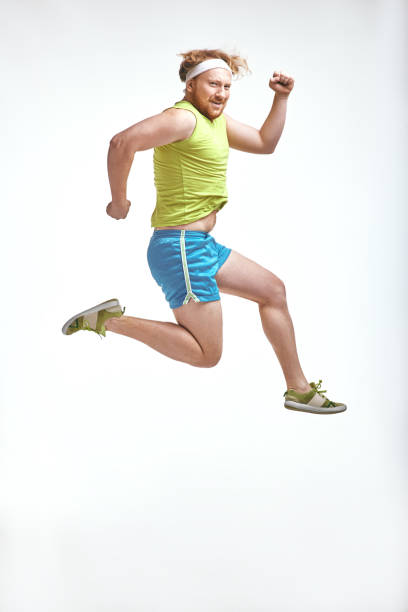 istock Red haired, bearded, plump man jumps in sportswear 1070620164