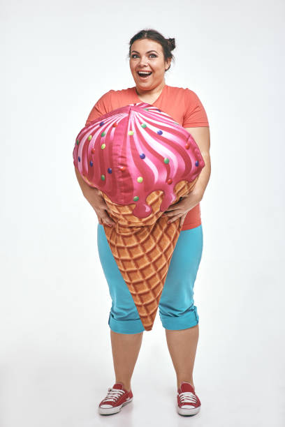 istock Brunette, chubby woman is holding a huge ice cream 1070620400