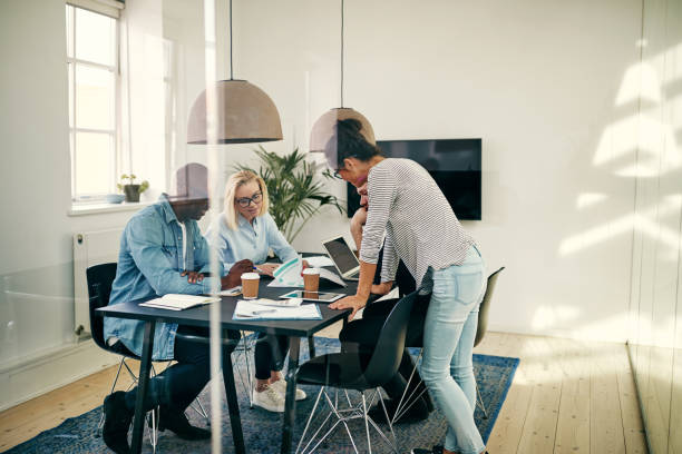 istock Diverse young businesspeople discussing paperwork together in an office 1070622142