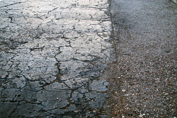 istock dried cracked black asphalt roadway texture 1070623024
