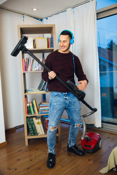 istock Musical Man Cleaning The House And Enjoying 1070627816