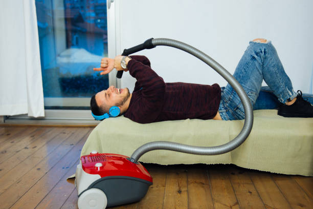 istock Musical Man Cleaning The House And Enjoying 1070629170