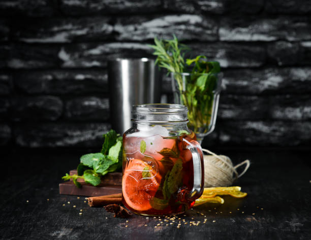 istock Cold drink with lemon mint in a glass cup. On a wooden background. 1070631148
