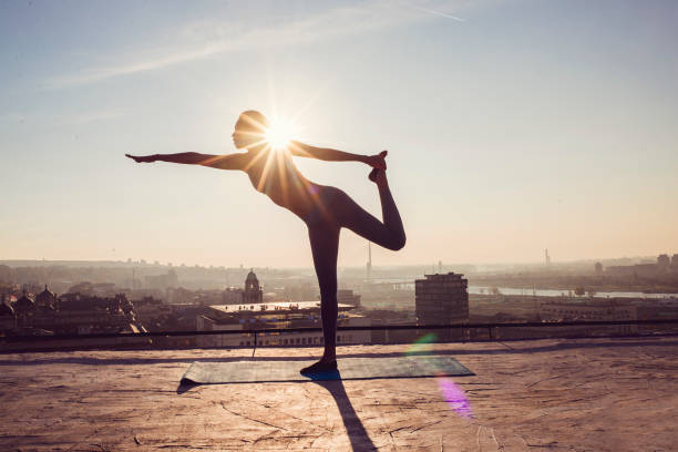 istock woman doing yoga on the rooftop 1070631896