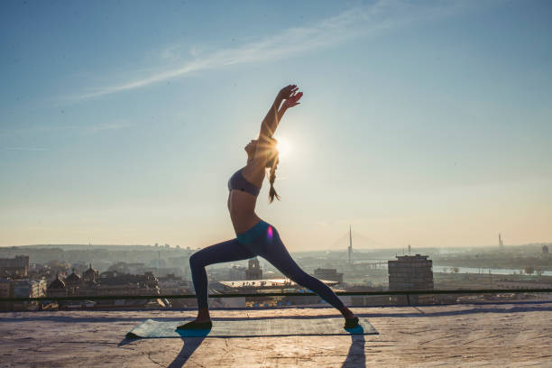 istock woman doing yoga on the rooftop 1070632052