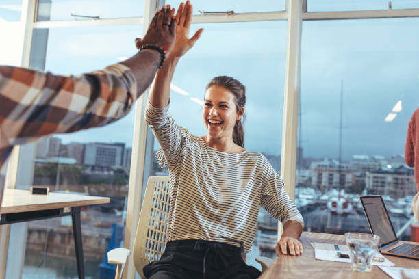 istock Coworkers celebrating success in office 1070632818