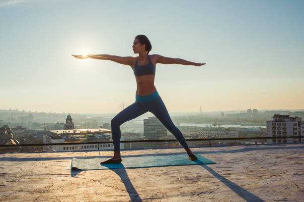 istock woman doing yoga on the rooftop 1070632870
