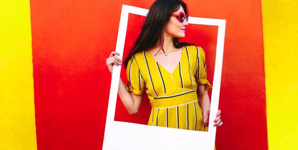 istock Beautiful woman with a blank picture frame 1070638144