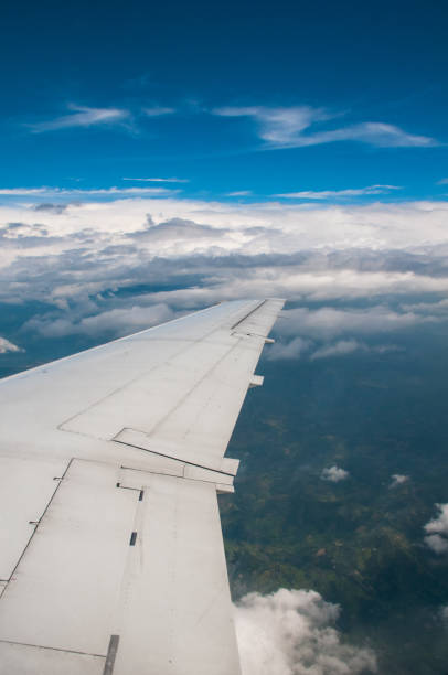 Aircraft wing seen from the window in the middle of the flight