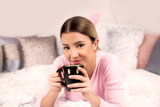 istock Young woman holding cup with coffee 1070655796