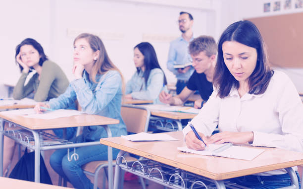 istock Smiling schoolgirl is learning and answering the question on paper 1070671124