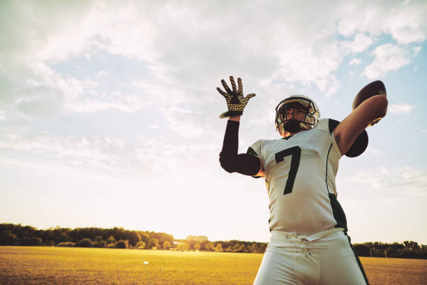 istock Football quarterback about to throw a pass during team practice 1070671992