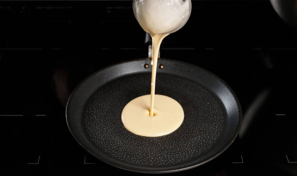 istock Pancake dough being poured on a pan 1070674934