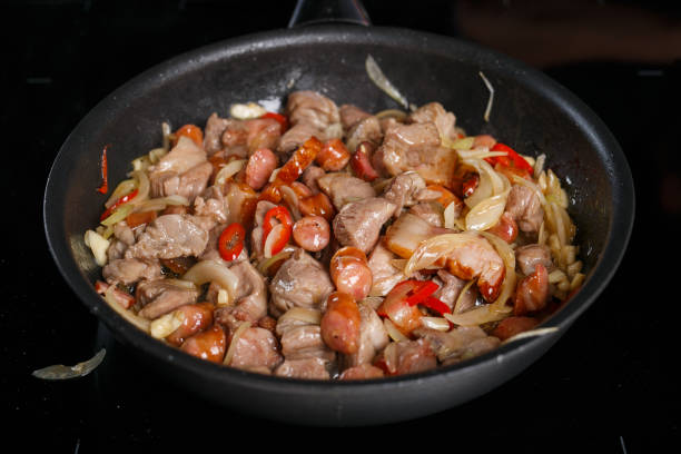 istock Frying pan with different kinds of meat, onions and chilli 1070674938