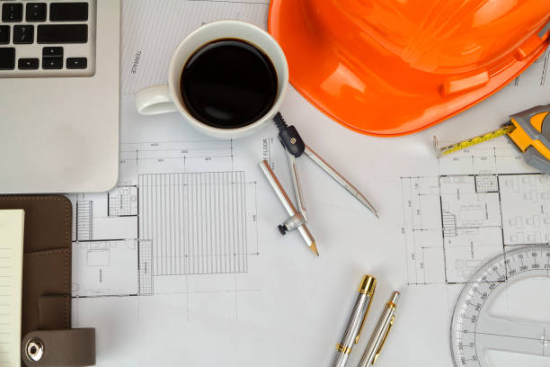 istock Cup of coffee with measurement tool and blueprint, architectural concept 1070682998