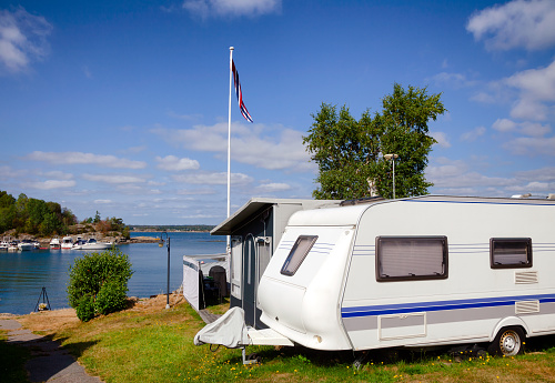 Camper trailer and cabin at seaside caravan park in Southern Norway