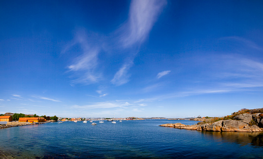 Panoramic view of Stavern harbour as seen from the Citadel Island with ochre coloured historic buildings of Staverns Fortress (Fredriksvern), Larvik, Vestfold, Norway