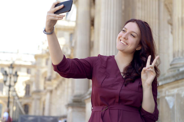 istock young woman walks in Paris (with smartphone) 1070690928