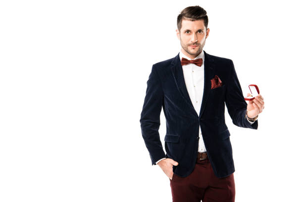 istock Handsome man in suit with ring box isolated on white 1070691948
