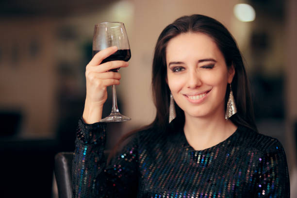 istock Woman Toasting With Red Wine at a Party 1070695846