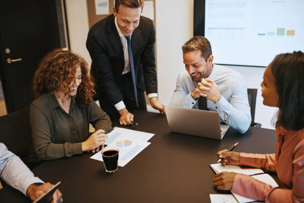 istock Diverse businesspeople discussing a graph together during an office meeting 1070699154