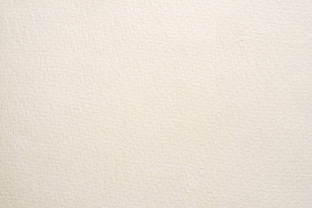 textured paper for watercolor painting. beige factured background, suitable as a backdrop for business presentation. stock photo