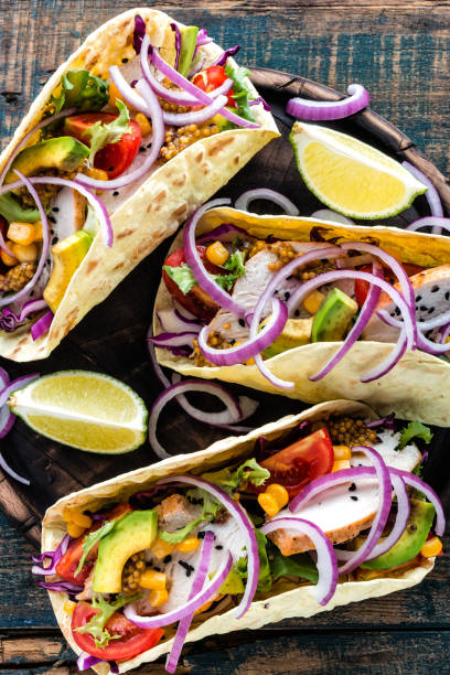 istock Mexican tacos with chicken meat, vegetables and fresh greens 1070704092