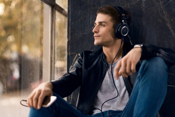 istock Young man enjoying while listening music from MP3 player. 1070708312
