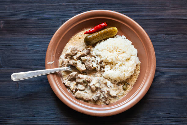 istock eating of Beef Stroganoff dish from brown plate 1070709726