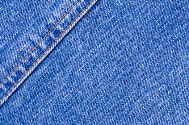 istock Blue jeans material fabric texture fashion seam fittings macro 1070710404