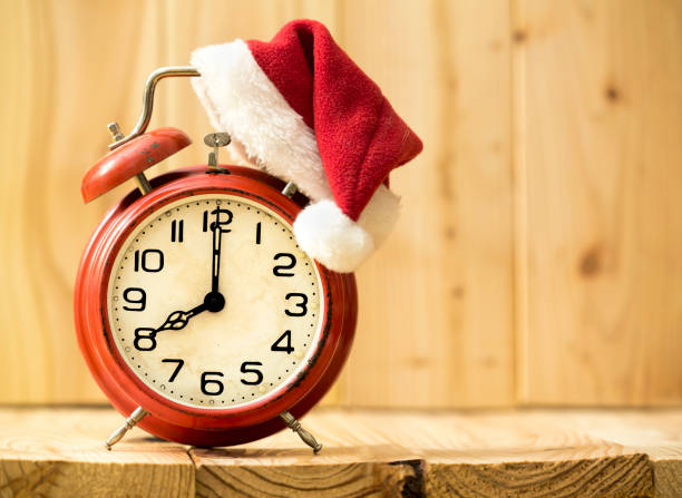 istock Christmas time - red alarm clock with santa hat 1070710498