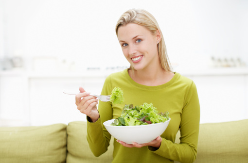 Hand holding fork with white background. Eating disorder concept