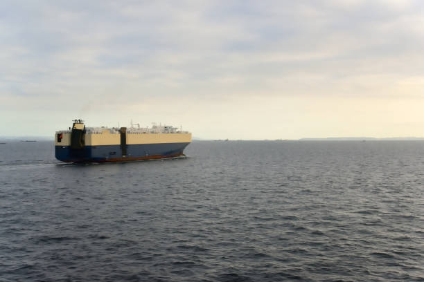 A vehicles carrier, car transporter, riding high in the water approaches Yokohama to pick up a load of new automobiles to be exported around the world.