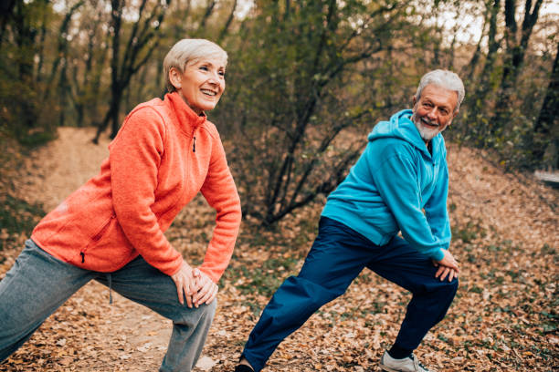 istock Senior couple doing calf stretches in a park 1070713634