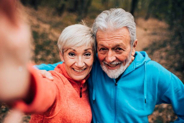 istock Smiling senior couple making a selfie in a park 1070713874