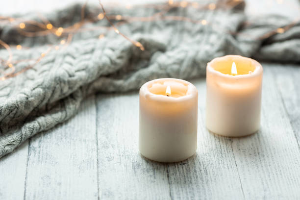 Two Candles Sweater Wooden Table Lights Garland stock photo