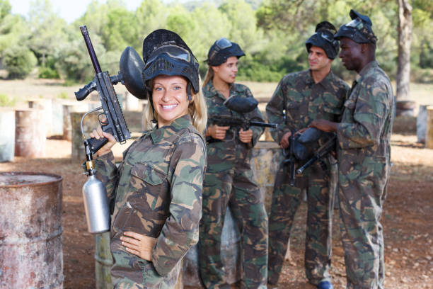 istock female paintball player with marker gun ready for game 1070718820
