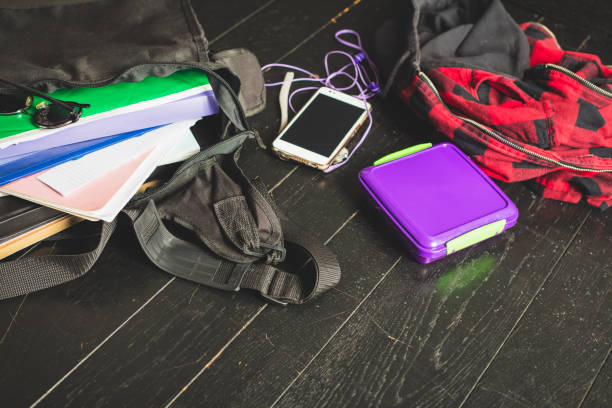 istock Opened schoolbag on the black wooden floor 1070724100