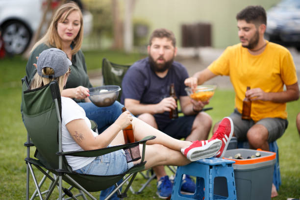 Group of people tailgating and drinking beer Group of people having fun while tailgating tailgate party photos stock pictures, royalty-free photos & images