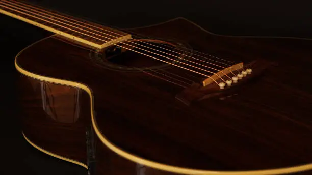 part of a beautiful real wood acoustic guitar in a dimly light