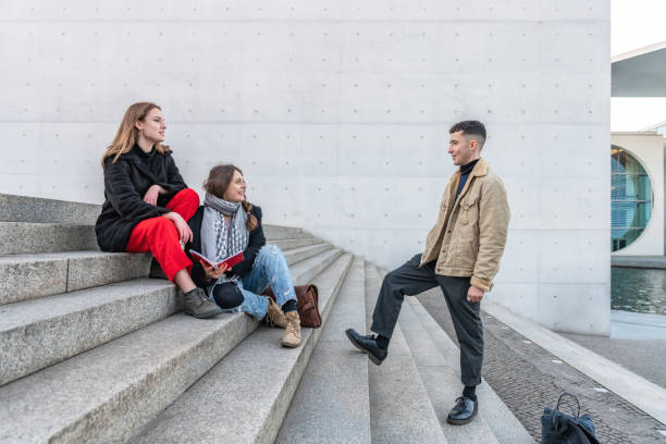 istock three young friends on stone stairs outdoors 1070726814