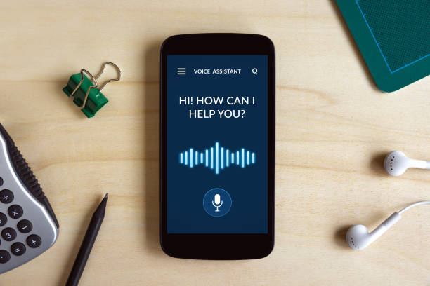 istock Voice assistant concept on smart phone screen on wooden desk 1070726838