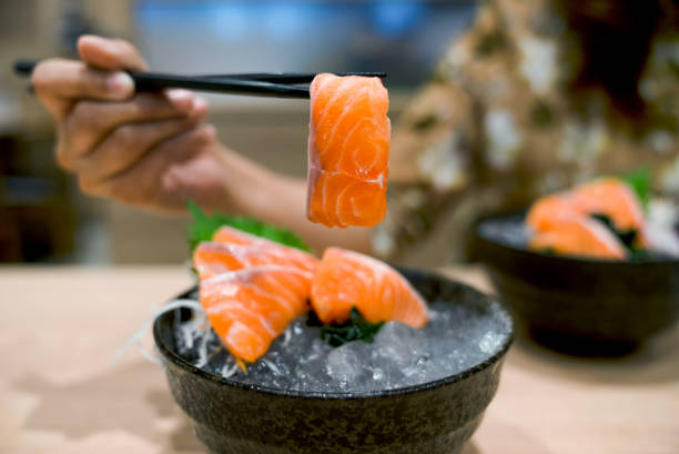istock Salmon sashimi with chopsticks - Raw salmon 1070727152
