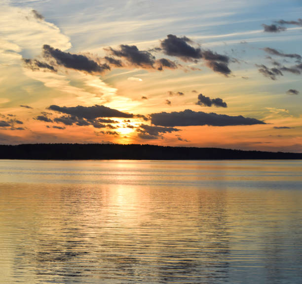 istock evening sunset on the river sea bright light reflection water clouds sky 1070734776