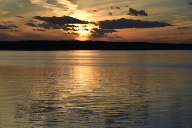 istock evening sunset on the river sea bright light reflection water clouds sky 1070734940
