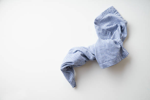 istock Striped blue and white textile napkin folded on white background. Food styling element 1070737458