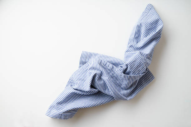 istock Striped blue and white textile napkin folded on white background. Food styling element 1070737466